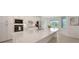 Modern kitchen featuring a large island, stainless steel appliances, and bright natural light at 17449 Sandpearl Rd, Venice, FL 34293