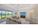 Stylish living room featuring a comfortable sectional sofa and large screen TV at 17449 Sandpearl Rd, Venice, FL 34293