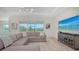 Cozy living room featuring a plush sectional sofa, neutral color palette, and sliding glass doors at 17449 Sandpearl Rd, Venice, FL 34293
