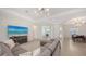 Open-concept living space featuring modern lighting, neutral colors, and easy access to other rooms at 17449 Sandpearl Rd, Venice, FL 34293
