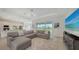 Cozy living room featuring a plush sectional sofa, neutral color palette, and open floor plan at 17449 Sandpearl Rd, Venice, FL 34293