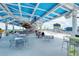 Relaxing outdoor lounge area with casual dining tables and a bar for social gatherings at 17449 Sandpearl Rd, Venice, FL 34293