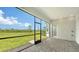 Screened-in patio with brick flooring and a view of the lush green lawn and blue sky at 17449 Sandpearl Rd, Venice, FL 34293