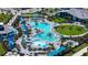 Resort-style community pool with lounge chairs, umbrellas, and lush landscaping, ideal for relaxation and recreation at 17449 Sandpearl Rd, Venice, FL 34293