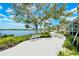 Picturesque lakefront walkway with benches, lush landscaping and ample room for walking at 17449 Sandpearl Rd, Venice, FL 34293