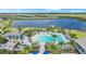 Overhead view showcasing a stunning community pool, waterfront views, and tropical landscaping at 17927 Palmiste Dr, Bradenton, FL 34202
