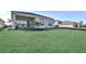 Sprawling backyard featuring well-maintained green lawn and a distant view of neighboring homes and a treeline at 17927 Palmiste Dr, Bradenton, FL 34202