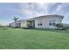 Sprawling backyard featuring well-maintained green lawn and a distant view of neighboring homes and a treeline at 17927 Palmiste Dr, Bradenton, FL 34202