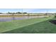 Serene backyard view overlooking a tranquil pond, surrounded by lush landscaping and bordered by a decorative fence at 17927 Palmiste Dr, Bradenton, FL 34202