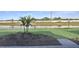 Serene backyard view overlooking a tranquil pond, surrounded by lush landscaping and bordered by a decorative fence at 17927 Palmiste Dr, Bradenton, FL 34202