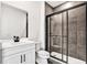 Modern bathroom featuring a tiled shower, and white vanity with dark hardware at 17927 Palmiste Dr, Bradenton, FL 34202