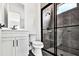 Modern bathroom featuring a tile shower, and white vanity with dark hardware at 17927 Palmiste Dr, Bradenton, FL 34202