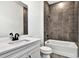 Modern bathroom featuring a tub with tile surround, and white vanity with dark hardware at 17927 Palmiste Dr, Bradenton, FL 34202