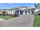 Charming home featuring a manicured lawn, lush plantings, and a spacious driveway leading to a two-car garage at 17927 Palmiste Dr, Bradenton, FL 34202