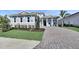 Charming home featuring a manicured lawn, lush plantings, and a spacious driveway leading to a two-car garage at 17927 Palmiste Dr, Bradenton, FL 34202
