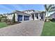 Charming home featuring a manicured lawn, lush plantings, and a spacious driveway leading to a two-car garage at 17927 Palmiste Dr, Bradenton, FL 34202