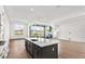 Modern kitchen with a gray island, quartz countertops, and stainless steel appliances at 17927 Palmiste Dr, Bradenton, FL 34202