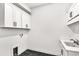 Clean laundry room with tiled floor, cabinets, and stainless steel sink at 17927 Palmiste Dr, Bradenton, FL 34202