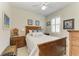 Cozy bedroom featuring a wooden bed frame, plantation shutters, and decorative bedside tables at 19038 Lappacio St, Venice, FL 34293