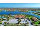 Panoramic aerial view capturing the community clubhouse, lake, and beautifully designed homes at 19038 Lappacio St, Venice, FL 34293