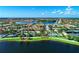 Bird's eye view highlighting the community's pool, common areas, and lush landscaping next to a lake at 19038 Lappacio St, Venice, FL 34293