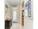 Bright foyer with tiled floors, decorative glass door, and elegant furnishings at 19038 Lappacio St, Venice, FL 34293