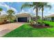 Charming single-story home featuring a brick driveway, lush landscaping, and well-maintained lawn at 19038 Lappacio St, Venice, FL 34293