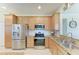 Well-equipped kitchen with stainless steel appliances and light wood cabinetry at 19038 Lappacio St, Venice, FL 34293