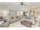 Spacious living area with comfortable seating, ceiling fan, and open view to the dining area at 19038 Lappacio St, Venice, FL 34293