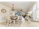 Open concept living room and dining area with stylish furnishings and abundant natural light at 19038 Lappacio St, Venice, FL 34293