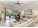 Inviting living room with cozy seating, tile floors, and view of the outdoor living area at 19038 Lappacio St, Venice, FL 34293