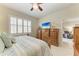 Well-lit bedroom featuring matching dressers and plantation shutters at 19038 Lappacio St, Venice, FL 34293