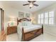 Cozy bedroom featuring a wood bed frame, plantation shutters and coordinating decor at 19038 Lappacio St, Venice, FL 34293