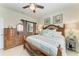 Comfortable bedroom with accent furniture, neutral paint and a sliding barn door at 19038 Lappacio St, Venice, FL 34293