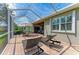 Covered brick patio features a table and chairs, lounge chairs, and an open layout at 19038 Lappacio St, Venice, FL 34293