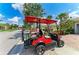 Golf cart parked on a brick paver street in a neighborhood with lush landscaping at 19038 Lappacio St, Venice, FL 34293