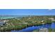 Community with lush greenery, a pond, and an overview of the homes and surrounding landscape at 20 Whispering Sands Dr # 1201, Sarasota, FL 34242