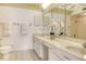 A clean bathroom features double sinks, a large mirror, and lots of counter space at 20 Whispering Sands Dr # 1201, Sarasota, FL 34242