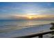 Scenic beachfront view during sunset, with calm ocean waters and a sandy shoreline, perfect for relaxation and recreation at 20 Whispering Sands Dr # 1201, Sarasota, FL 34242