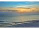 Sunset beach view showcases golden light on beach, ocean, and bright sky at 20 Whispering Sands Dr # 1201, Sarasota, FL 34242