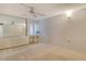 Bedroom featuring neutral carpet, built-in shelves and drawers, and ceiling fan at 20 Whispering Sands Dr # 1201, Sarasota, FL 34242