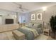 A stylishly staged bedroom features a large bed and built-in vanity at 20 Whispering Sands Dr # 1201, Sarasota, FL 34242