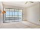 Bright bedroom featuring neutral carpet and slider doors to the balcony showing ocean views at 20 Whispering Sands Dr # 1201, Sarasota, FL 34242