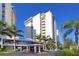 Elegant building exterior with lush tropical landscaping, offering a luxurious and inviting entrance to residents and guests at 20 Whispering Sands Dr # 1201, Sarasota, FL 34242
