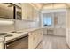 Well-lit kitchen with white cabinets, countertop space, and modern appliances at 20 Whispering Sands Dr # 1201, Sarasota, FL 34242