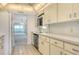 Clean kitchen featuring stainless steel appliances and access to open living area at 20 Whispering Sands Dr # 1201, Sarasota, FL 34242