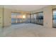 Bright open living room space with ocean views from sliding glass doors and balcony at 20 Whispering Sands Dr # 1201, Sarasota, FL 34242