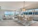 Bright living room and dining area with ocean views through sliding glass doors and modern furnishings at 20 Whispering Sands Dr # 1201, Sarasota, FL 34242