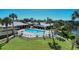 Community pool area featuring lounge chairs and lush landscaping at 20 Whispering Sands Dr # 1201, Sarasota, FL 34242
