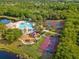 Aerial view of community amenities including a pool, tennis courts, playground, and basketball court at 224 Dahlia Ct, Bradenton, FL 34212